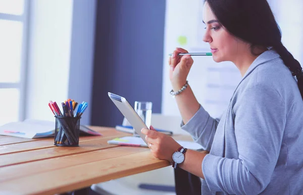 Pretty young female manager using modern digital tablet at office. — Stock Photo, Image