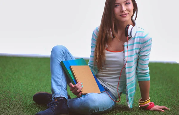 Yeşil çimlerde oturan genç bir kadın. Portreit genç bayan