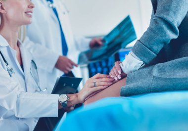 Doktor ve hasta tarama sonuçlarını tarama merkezinde tartışıyor.