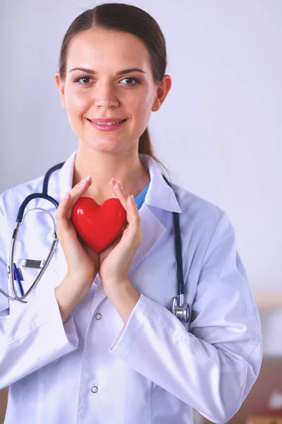 Beautiful Young Smiling Female Doctor Sitting Desk Holding Heart — Stock Photo, Image
