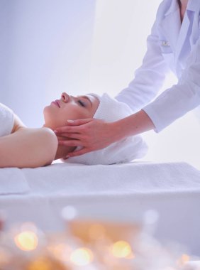 Masaj masasında uzanmış gözleri kapalı rahatlayan genç bir kadın. - Kadın. Spa salonu.