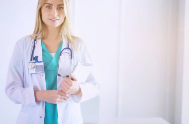 Tıp ofisinde kollarını kavuşturmuş kendine güvenen kadın doktorların portresi..