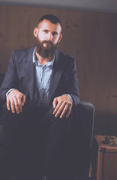 Businessman Sitting Sofa Office Lobby Isolated Dark Background — Stock Photo, Image