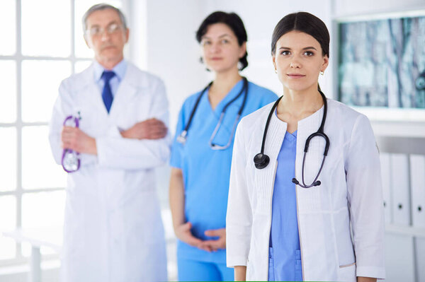 Group of doctors and nurses standing in the hospital room