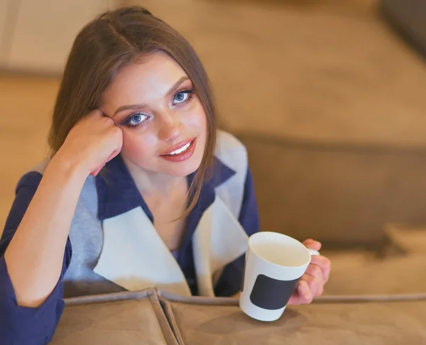 Young Woman Sitting Comfortable Sofa Cup Coffee Hands White Room — Stock Photo, Image