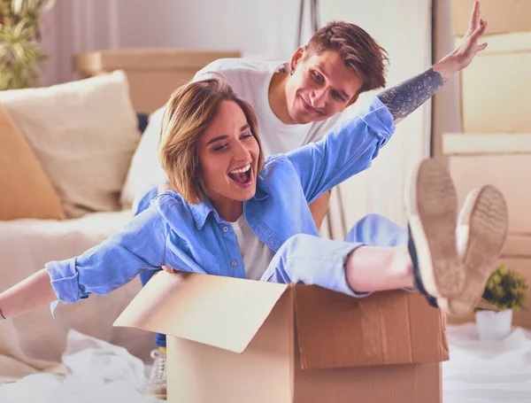 Mutlu çift eğleniyor ve yeni evlerinde karton kutularda geziyorlar..
