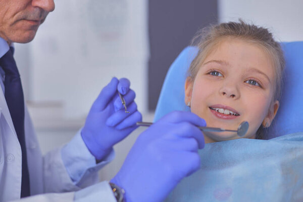 Little girl sitting in the dentists office.