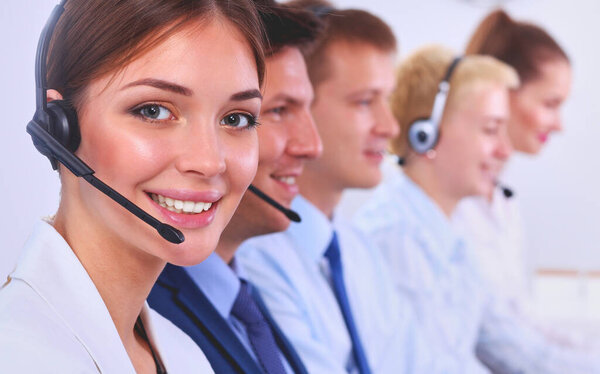 Attractive positive young businesspeople and colleagues in a call center office