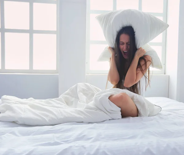 Young Caucasian Woman Covering Her Head Ears Pillows — Stock Photo, Image