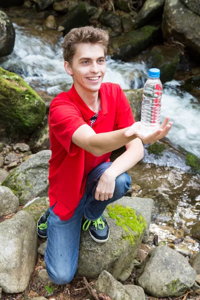 Young man with the  bottle of water — Stock Photo, Image