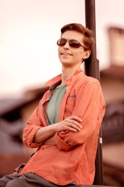 Ayakta duran yakışıklı bir genç adam.