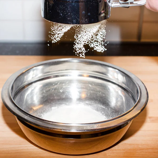 Peneirando flor branca através de uma peneira — Fotografia de Stock