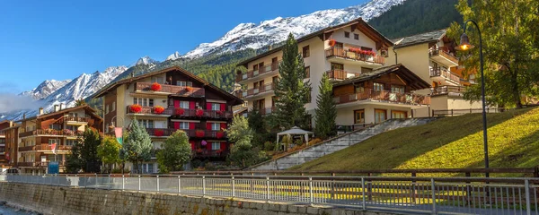 Zermatt, Switzerland street view in famous Swiss Alps ski resort, river, snow mountain peaks, banner
