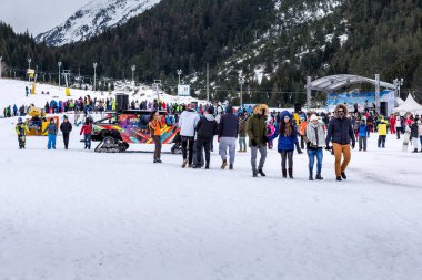 Bansko, Bulgaria - December 16, 2017: Bunderishka polyana season open, people and mountain with pine trees panorama