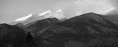 Bansko, Bulgaria travel winter landscape banner panorama of snow Pirin mountain peaks at sunrise, black and white