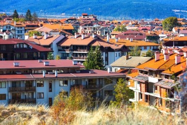 Bansko, Bulgaria town panorama with houses and colorful autumn trees