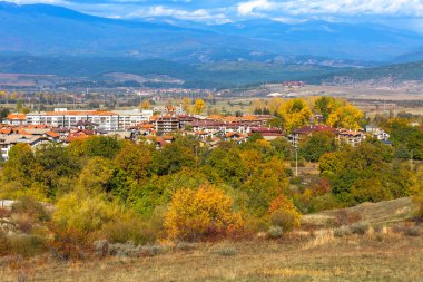 Bansko, Bulgaria town panorama with houses and colorful autumn trees