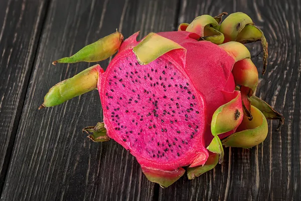 Half dragon fruit on a wooden planks — Stock Photo, Image