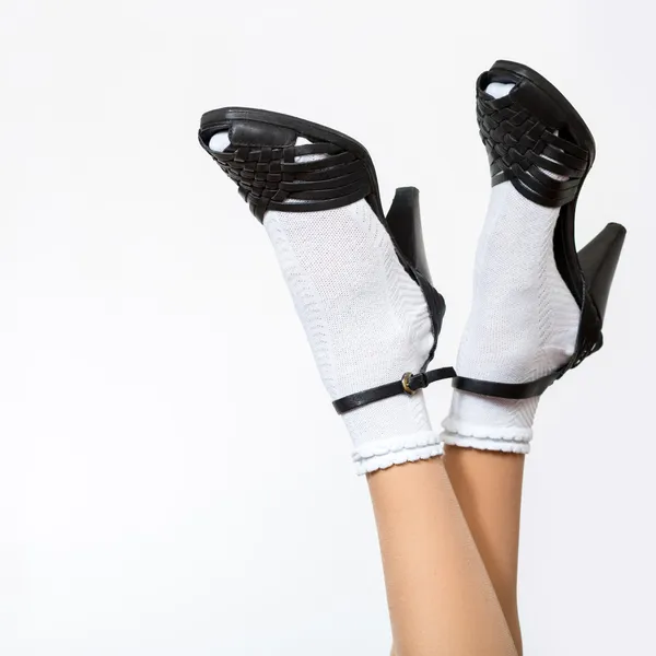 Female legs wearing socks and sandals — Stock Photo, Image