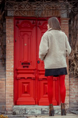 Genç kadın sonbaharda ya da kışın sokaklarda yürüyor eski şehir manzarasında