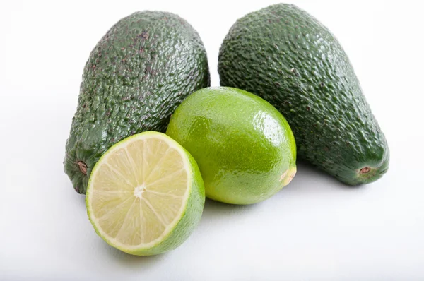 Avocados and limes — Stock Photo, Image