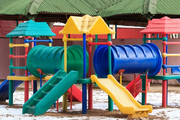 Plastic outdoor kids playground in winter — Stock Photo, Image