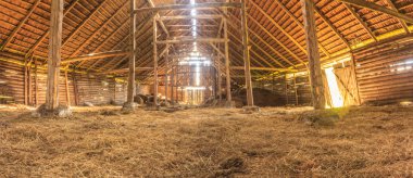 Panorama interior of old farm barn with straw clipart