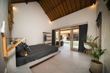 Havuz köşkünün yatak odasında rahat kral yatağı olan lüks bir iç dizayn. Yüksek tavanlı yatak odası. Ev, bina, otel, tatil köyü..