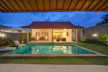 Alacakaranlıkta havuzu olan tatil villaları. Tatil kavramı.