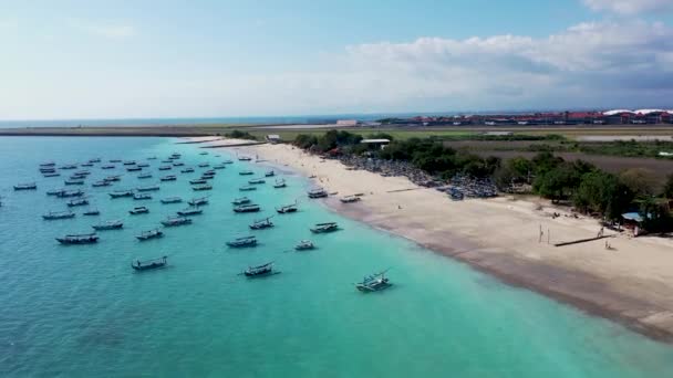 Jimbaran Bay Bali antenna. Hagyományos halászok hajó jukung kikötve a felszínre az öböl a nemzetközi repülőtéren — Stock videók