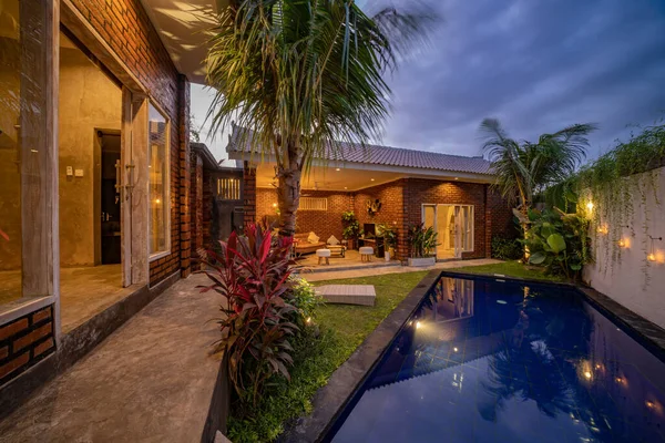 Modern house with swimming pool at night.