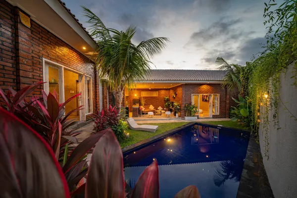 Modern house with swimming pool at night.