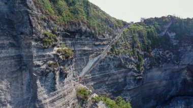 Uçurumun dibindeki Suwehan plajına giden yol. Endonezya 'nın Nusa Penida adasında