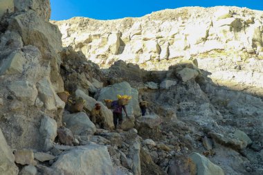 Kawah Ijen, Indonesia, 2 June, 2021. Worker carries sulfur inside Ijen crater in Ijen Volcano, Indonesia. He carries the load of around 60kg to the top of the rip and then 3km down
