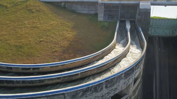 Aerial water in dam concrete spillway infrastructure at reservoir. Waterfall and stream in side channel spillway. Dam with drainage channel — Stock Photo, Image