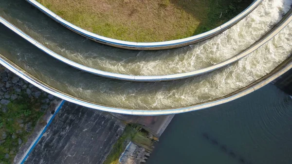 Aerial water in dam concrete spillway infrastructure at reservoir. Waterfall and stream in side channel spillway. Dam with drainage channel — Stock Photo, Image