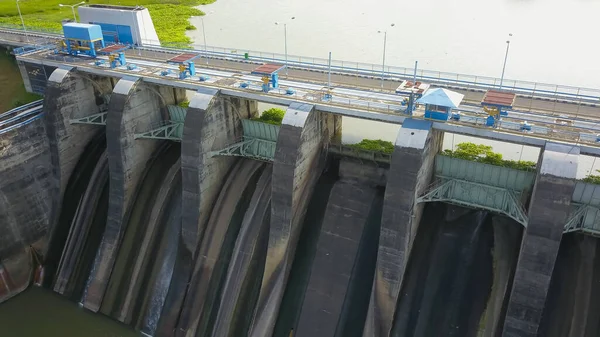 Hydroelectric dam with flowing water through gate, aerial view from drone. Bendungan Sampean Baru in Java, Indonesia — Stock Photo, Image