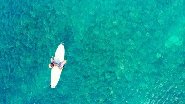 Surfisti in attesa di onde in un mare limpido vicino alla spiaggia pittoresca, vista drone. Aereo dall'alto in basso. Copia spazio per il testo — Foto Stock