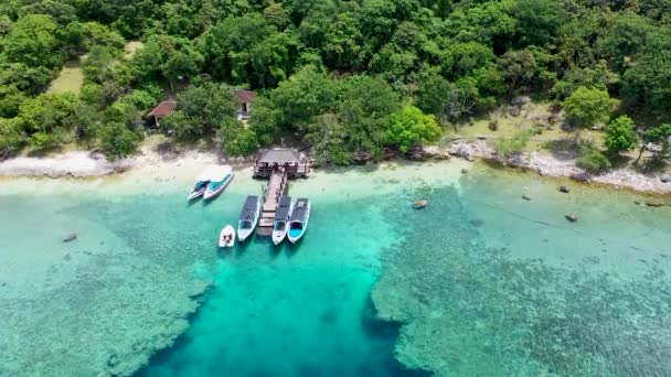 Un barco estacionado junto a la costa en la isla de Menjangan, Bali, Indonesia. Barcos estacionados en un arrecife de coral en el mar. Agua hermosa y clara. Algunos árboles en la orilla. Paraíso de vacaciones — Vídeos de Stock
