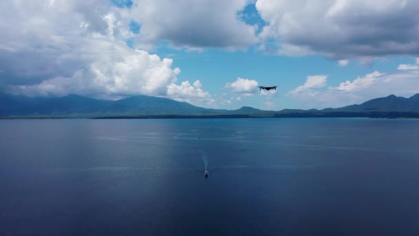 Sytyttäkää lennokki roikkumaan ilmaan luontotaustalle. Lentävä helikopteri Dron kaukosäädin Air Drone. Pieni lennokki kameralla. Moderni teknologia valokuvien ja videoiden kuvaamiseen ylhäältä — kuvapankkivideo