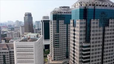 Aerial landscape of modern skyscrapers with glass windows in Jakarta central business district from a drone. Shot in 4k resolution.