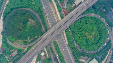 Aerial top down view on massive multi-level interchange on Jakarta city on a sunny summer day with light traffic.
