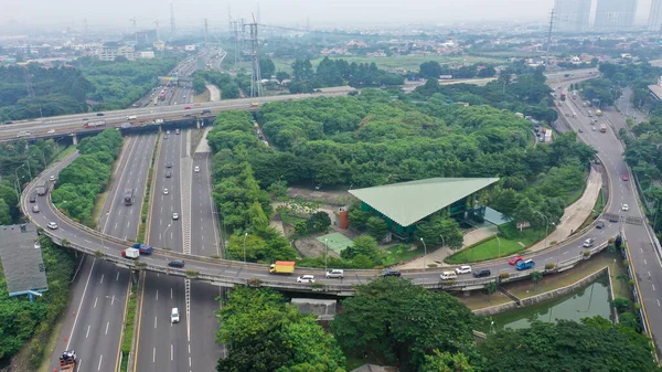 Road system. Road interchanges. Multi-level highways. The movement of vehicles on highways in different directions. View of multi-level roads from a height.