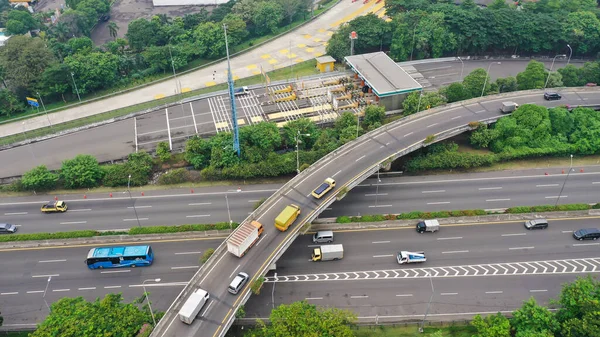 Road system. Road interchanges. Multi-level highways. The movement of vehicles on highways in different directions. View of multi-level roads from a height.