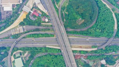 Aerial top down view on massive multi-level interchange on Jakarta city on a sunny summer day with light traffic.