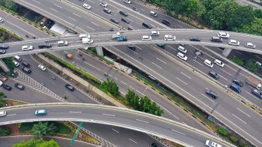 Aerial drone birds eye view photo of latest technology cross shape multi level road highway passing through city center.