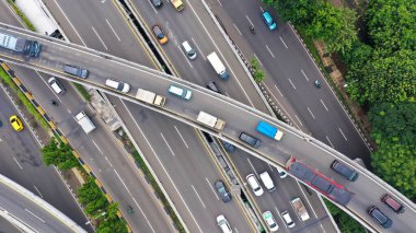 Aerial top down view on massive multi-level interchange on Jakarta city on a sunny summer day with light traffic.