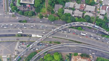Aerial top down view on massive multi-level interchange on Jakarta city on a sunny summer day with light traffic.