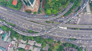 Aerial top down view on massive multi-level interchange on Jakarta city on a sunny summer day with light traffic.