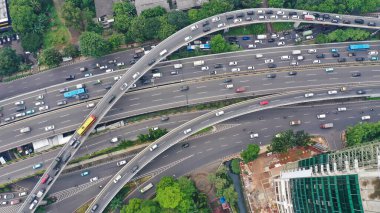 Aerial top down view on massive multi-level interchange on Jakarta city on a sunny summer day with light traffic.